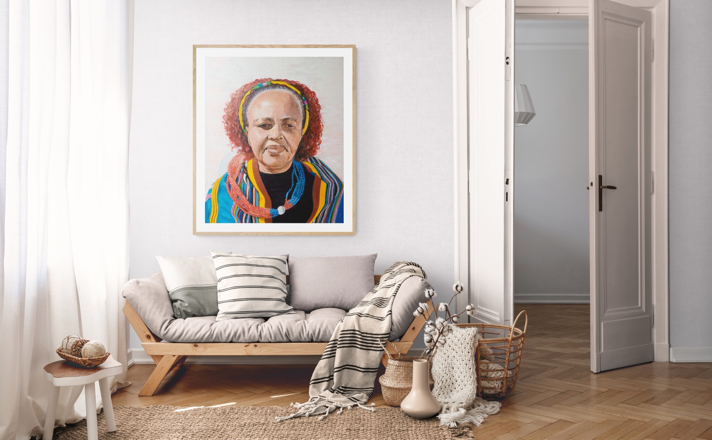 Matilda, framed in oak, hanging on a bright living-room wall above a wooden sofa with cushions and woven baskets